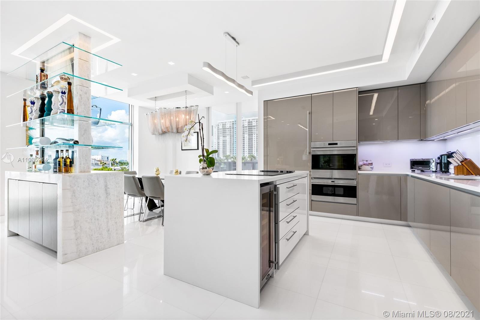 1201 20th Street, Unit PH08 Miami Beach, FL 33139 - Photo 10 of 28 a kitchen with white cabinets and stainless steel appliances