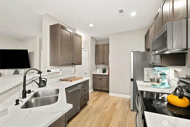 a kitchen with a sink appliances and cabinets