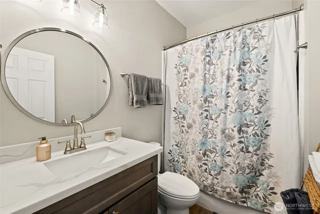 a bathroom with a sink toilet and mirror
