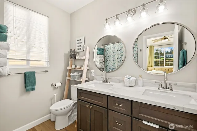 a bathroom with a toilet a sink and a mirror