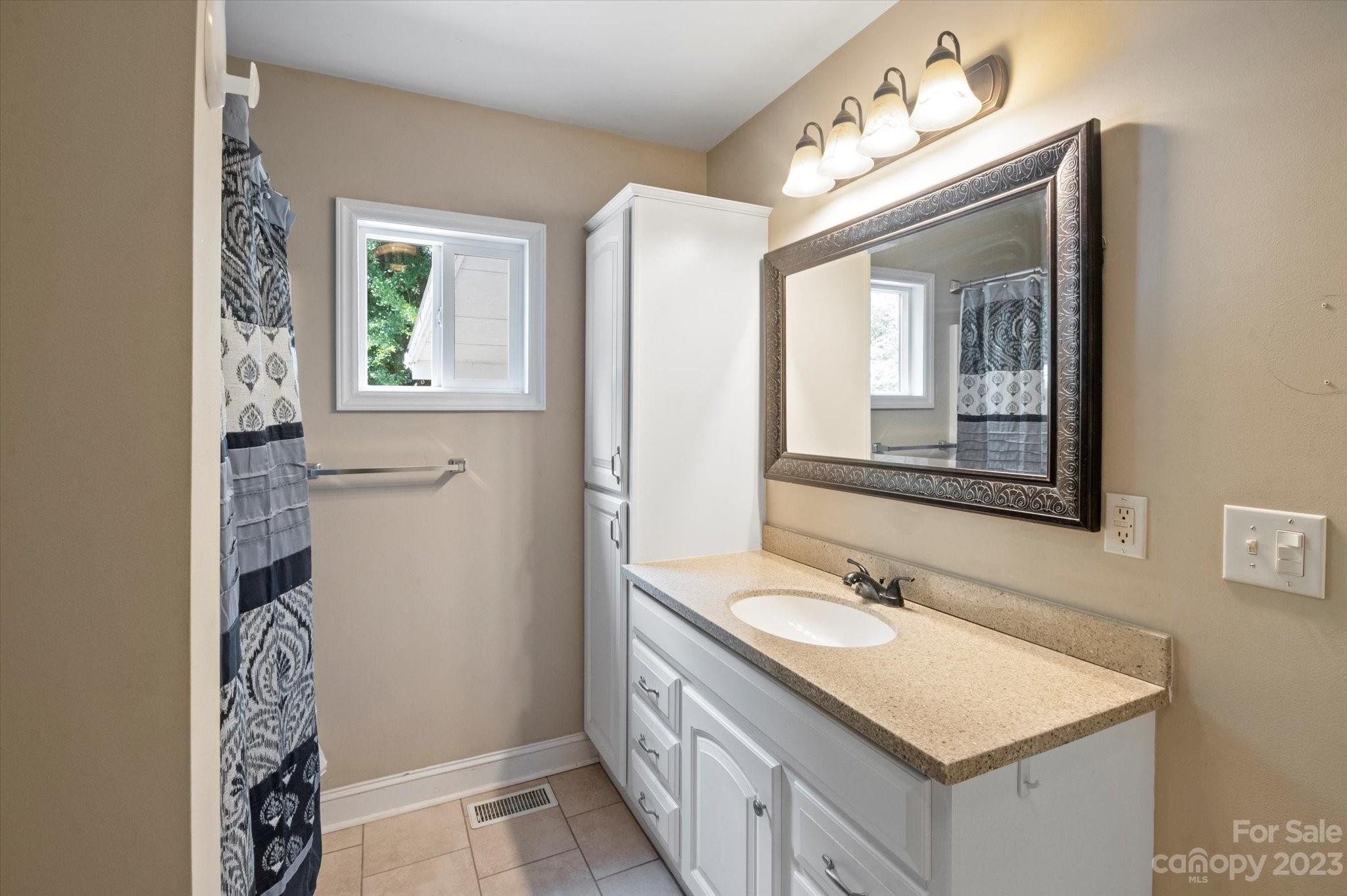 206 West View Street Rutherfordton, NC 28139 - Photo 15 of 39 a bathroom with a sink vanity granite toilet and a mirror
