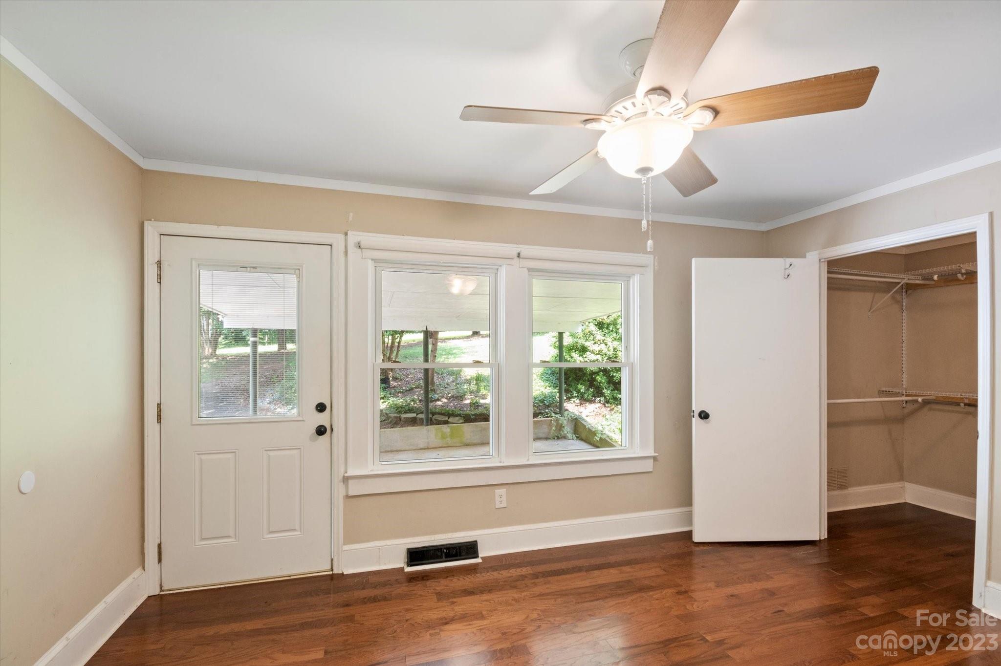 206 West View Street Rutherfordton, NC 28139 - Photo 21 of 39 an empty room with wooden floor fan and windows