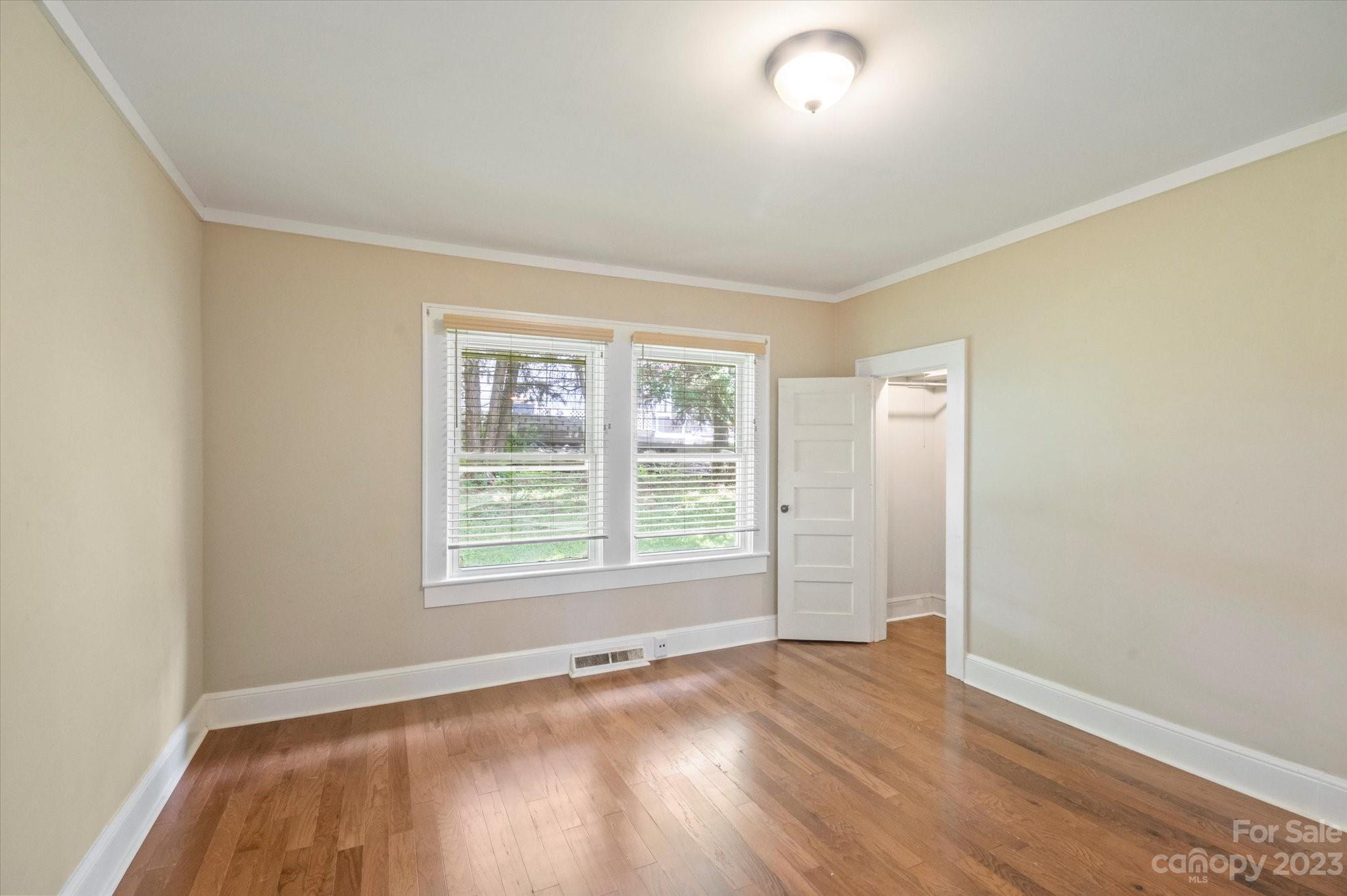206 West View Street Rutherfordton, NC 28139 - Photo 24 of 39 an empty room with wooden floor and windows