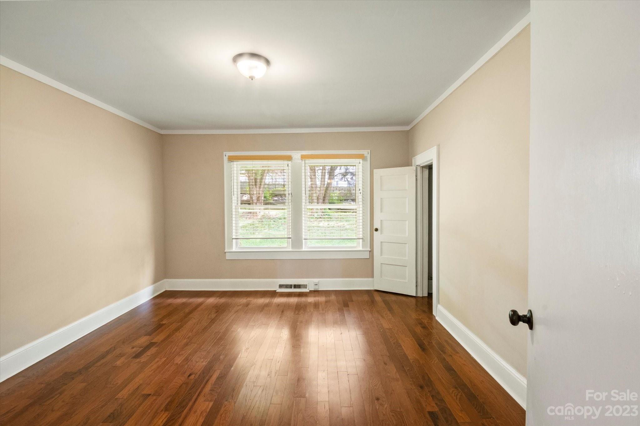 206 West View Street Rutherfordton, NC 28139 - Photo 26 of 39 an empty room with wooden floor and windows