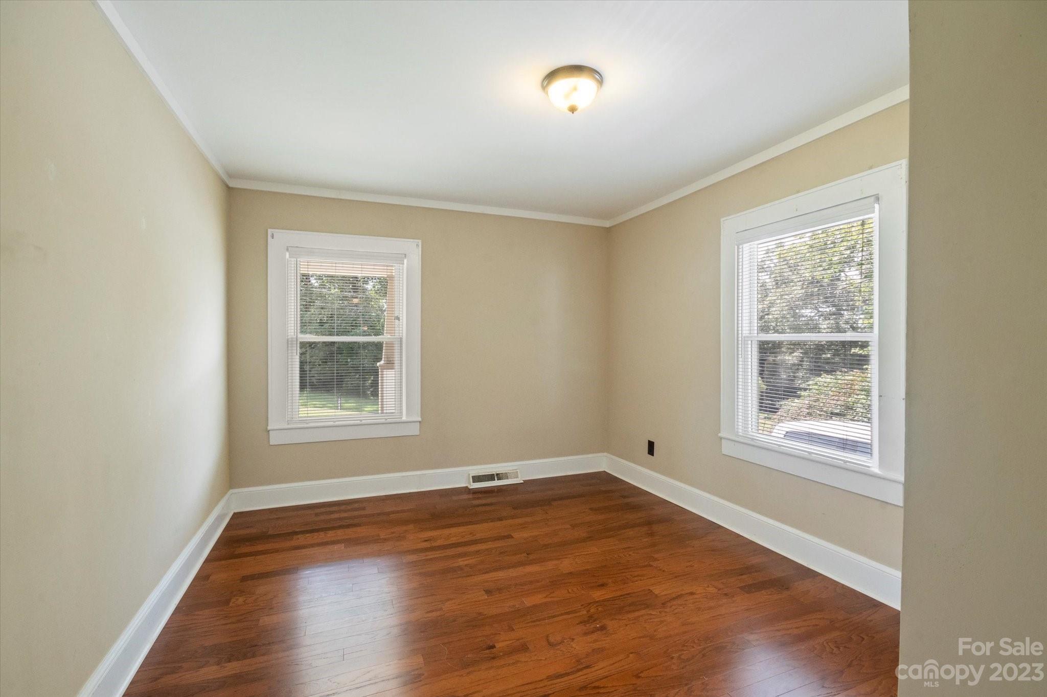 206 West View Street Rutherfordton, NC 28139 - Photo 29 of 39 an empty room with wooden floor and windows