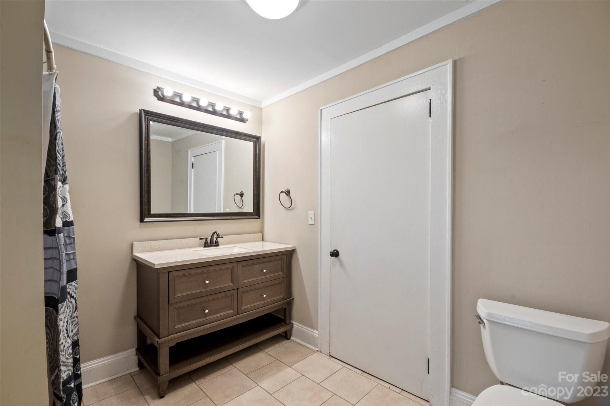 206 West View Street Rutherfordton, NC 28139 - Photo 10 of 39 a bathroom with a toilet a sink and a mirror