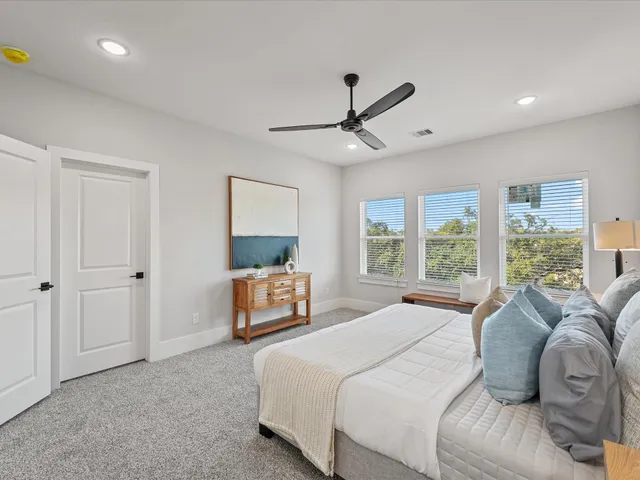 a bedroom with a bed a window and a chandelier