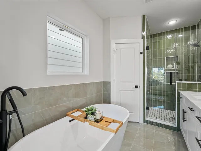 a bathroom with a bathtub and shower