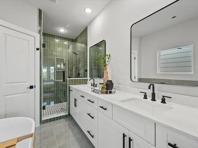 a bathroom with a double vanity sink toilet and shower