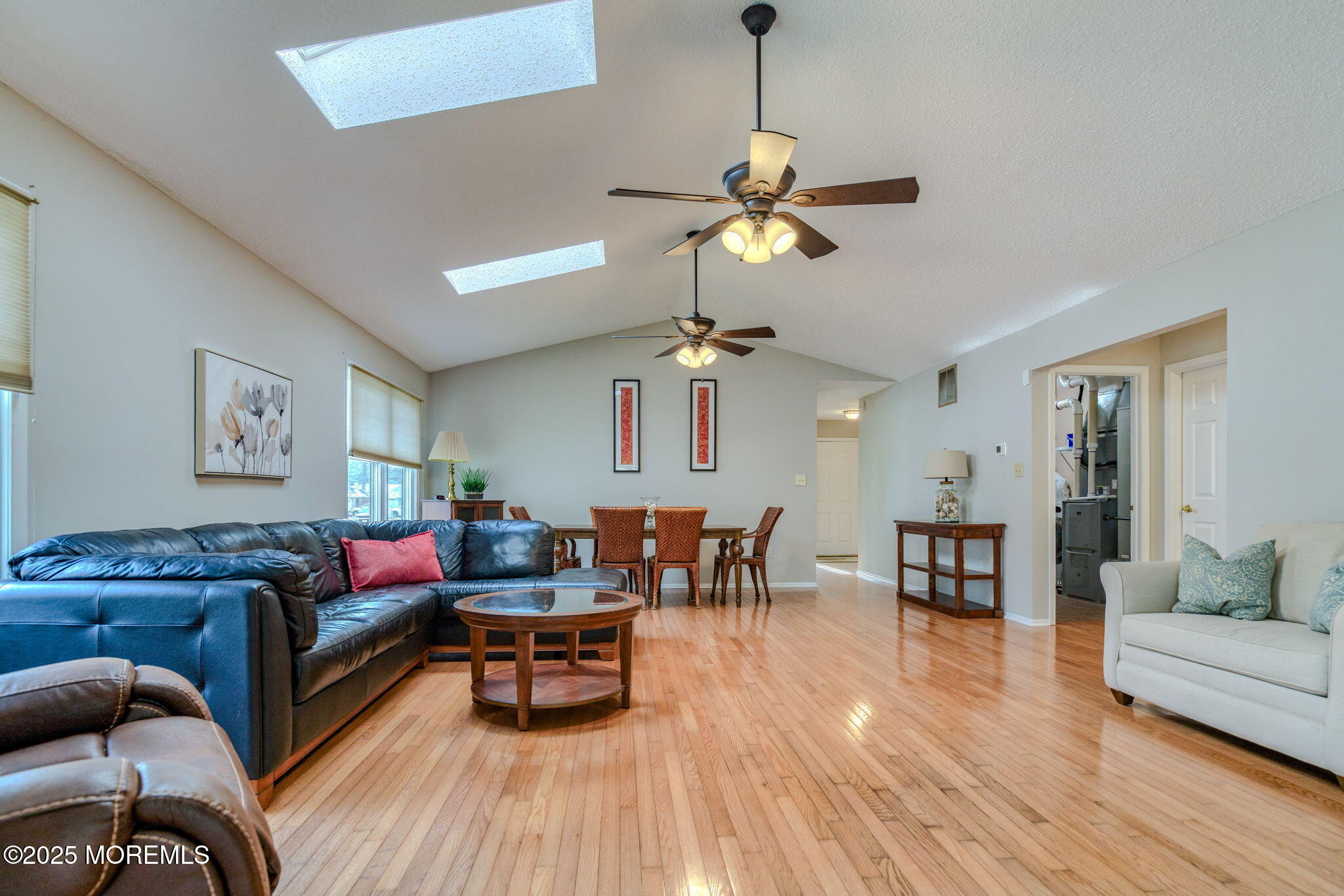 16 Deer Run Lane Brick, NJ 08724 - Photo 19 of 41 a living room with furniture a dining table and a chandelier