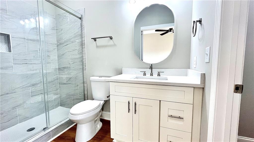 23 S Road Griffin, GA 30224 - Photo 16 of 32 a bathroom with a toilet a sink and mirror