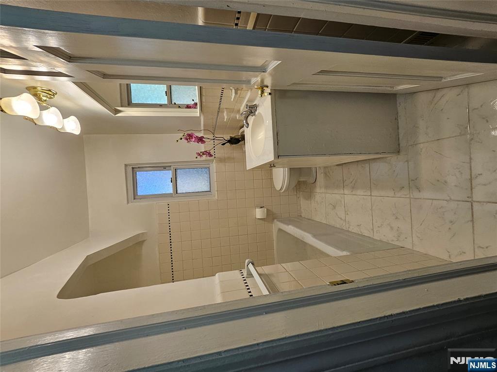 55 Rutgers Place River Edge, NJ 07661 - Photo 11 of 23 a bathroom with a sink a toilet and mirror