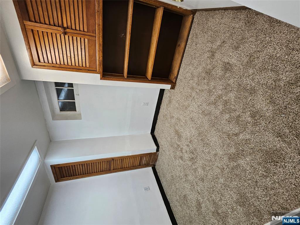 55 Rutgers Place River Edge, NJ 07661 - Photo 17 of 23 an empty room with wooden cabinet and a large window