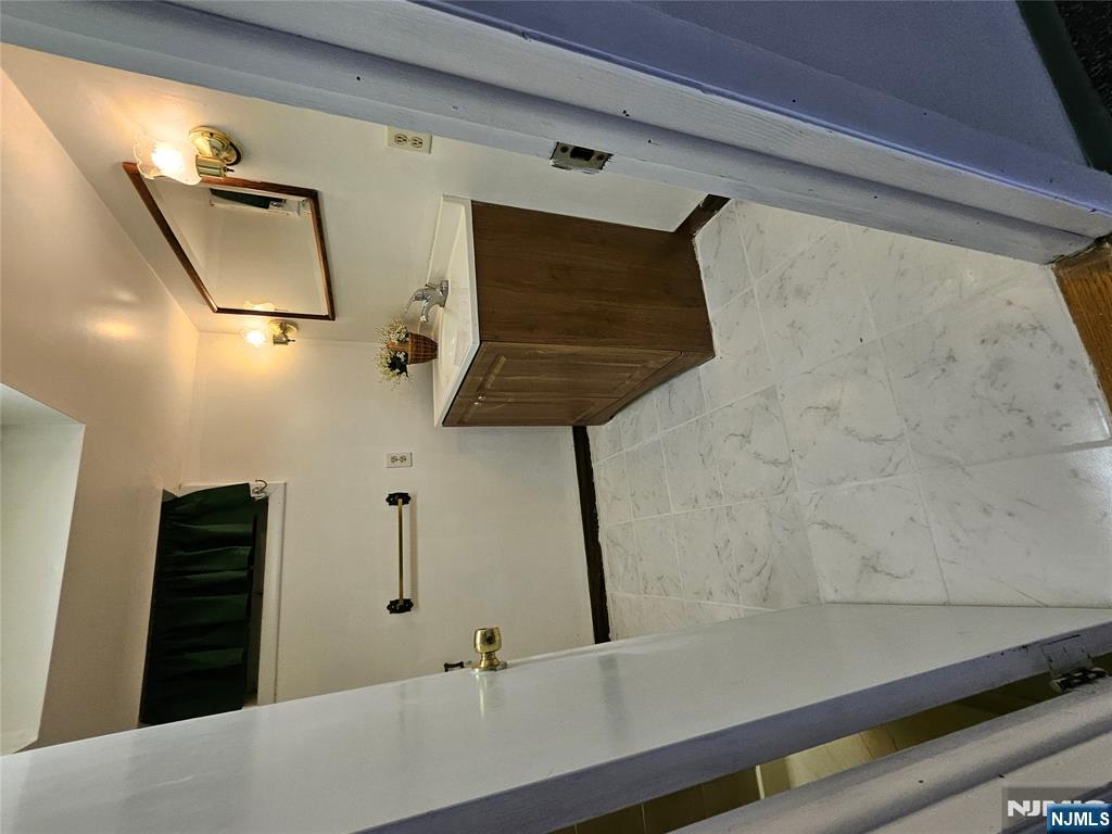 55 Rutgers Place River Edge, NJ 07661 - Photo 19 of 23 a bathroom with a sink and mirror