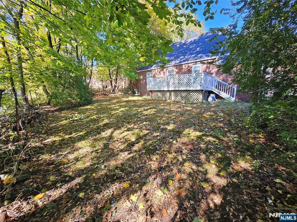 55 Rutgers Place River Edge, NJ 07661 - Photo 21 of 23 a backyard of a house with lots of green space