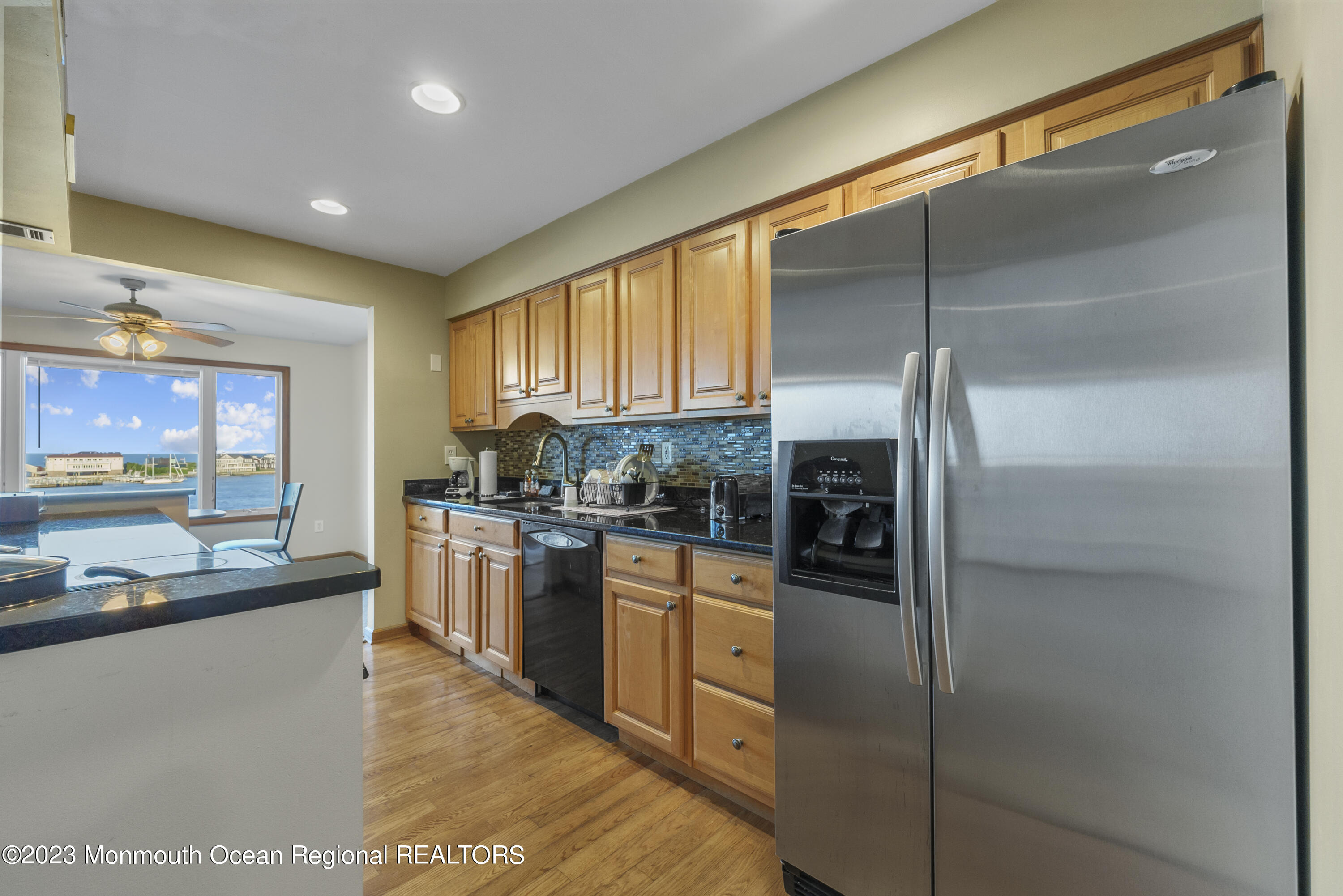 200 Portland Road, Unit A5 Highlands, NJ 07732 - Photo 7 of 30 a kitchen with stainless steel appliances granite countertop a refrigerator and a stove top oven