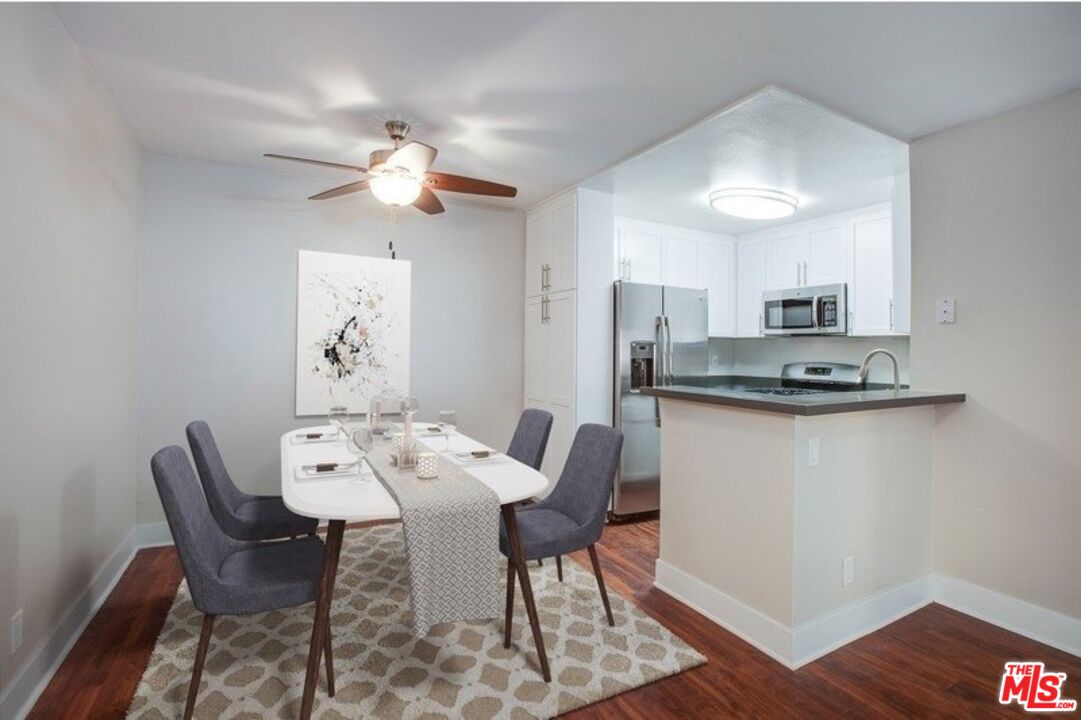 5922 Las Virgenes Road, Unit 566 Calabasas, CA 91302 - Photo 2 of 8 a view of a dining room with furniture and wooden floor