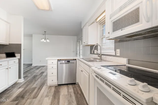 a kitchen with a stove a sink and a refrigerator
