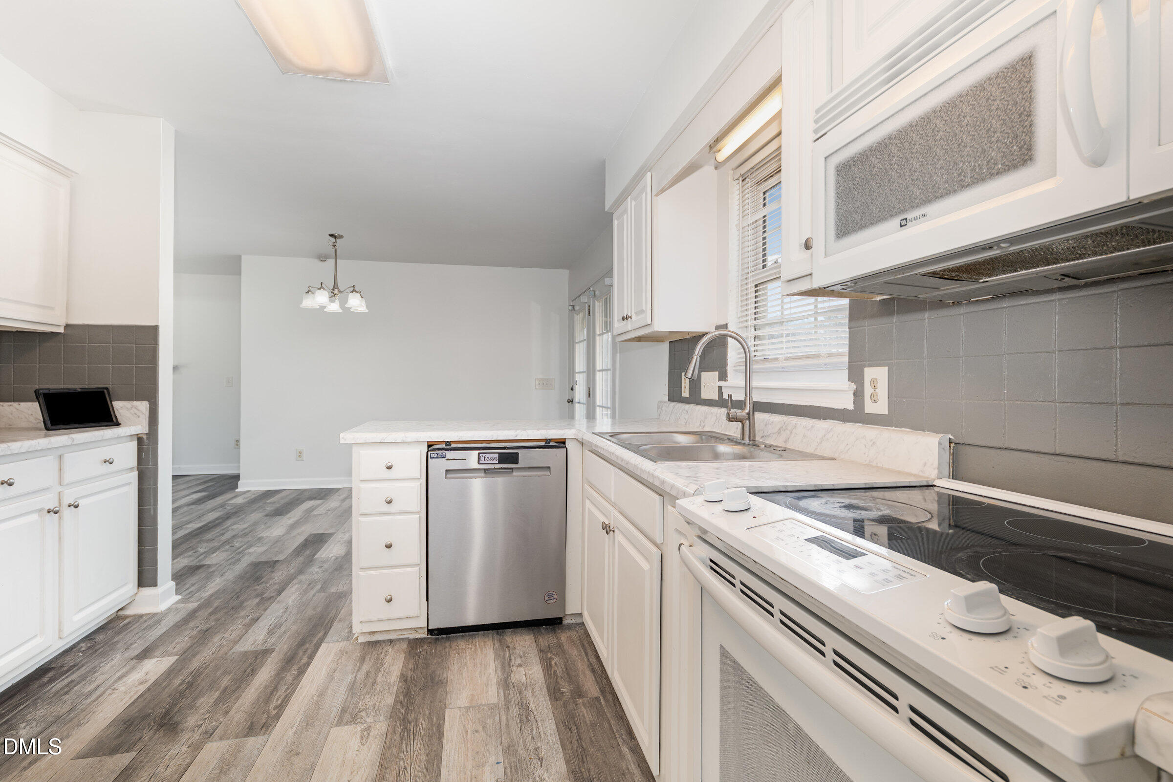 700 Thompson Road Graham, NC 27253 - Photo 11 of 34 a kitchen with a stove a sink and a refrigerator
