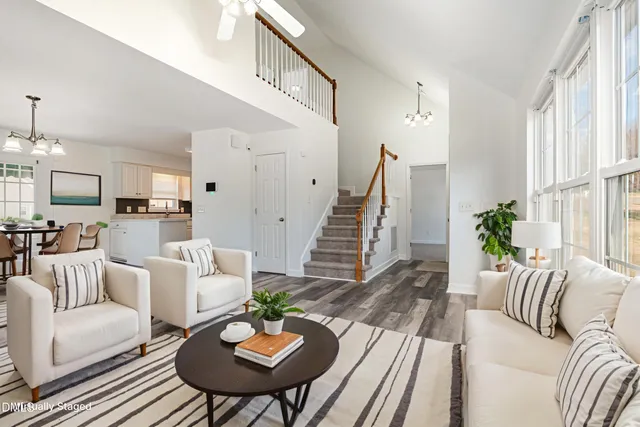 a living room with furniture fireplace and a table