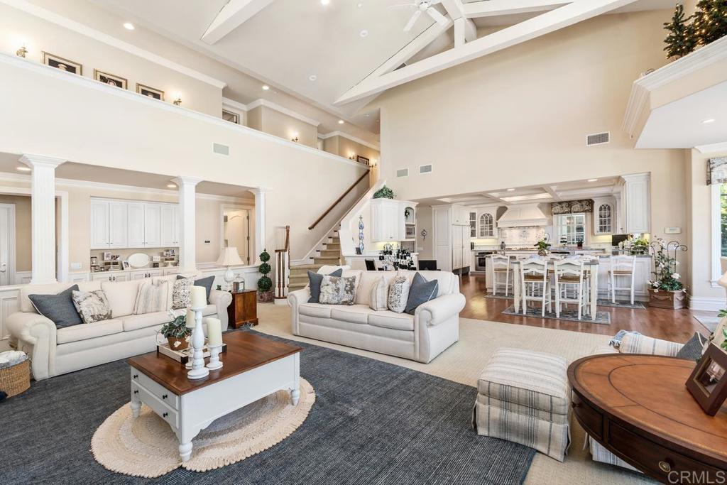 3056 Wildflower Drive Encinitas, CA 92024 - Photo 15 of 56 a living room with furniture or couches and a dining table with wooden floor