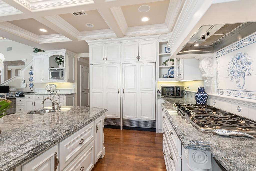 3056 Wildflower Drive Encinitas, CA 92024 - Photo 21 of 56 a kitchen with kitchen island granite countertop a sink stove and refrigerator