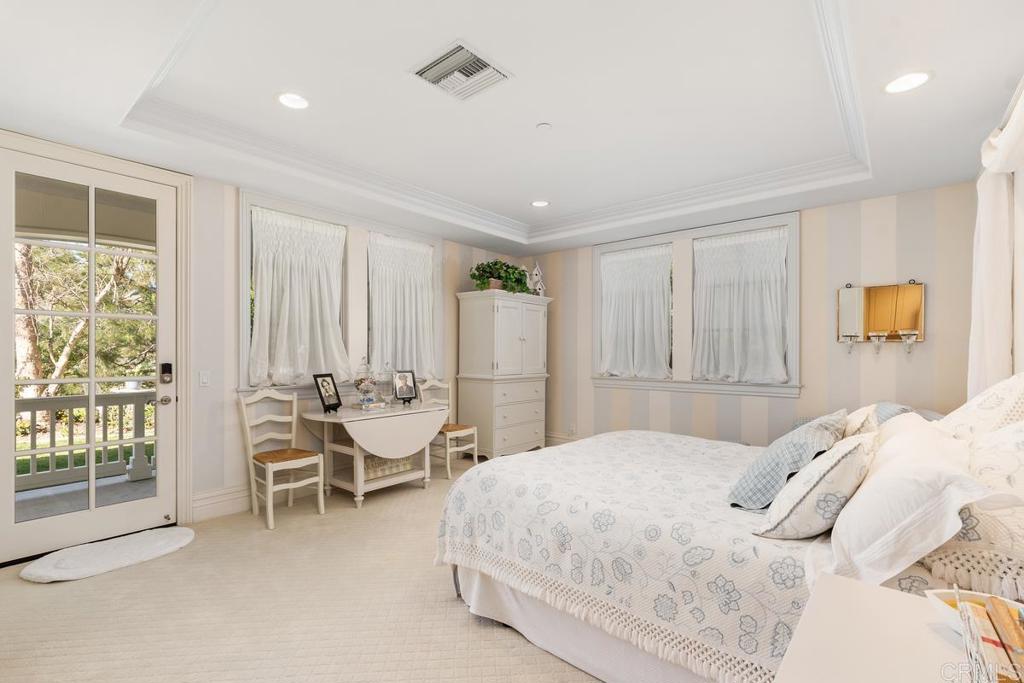 3056 Wildflower Drive Encinitas, CA 92024 - Photo 29 of 56 a bedroom with a bed and large windows
