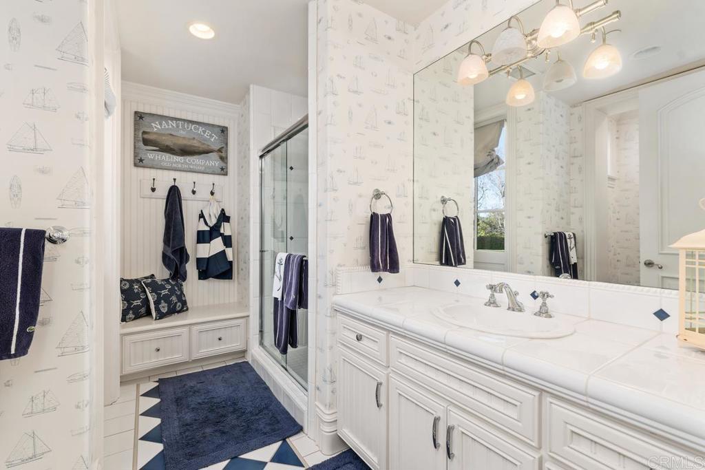 3056 Wildflower Drive Encinitas, CA 92024 - Photo 31 of 56 a bathroom with double vanity sink and mirror