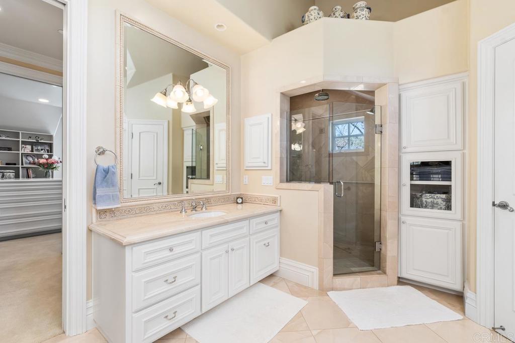 3056 Wildflower Drive Encinitas, CA 92024 - Photo 38 of 56 a spacious bathroom with a shower sink and mirror