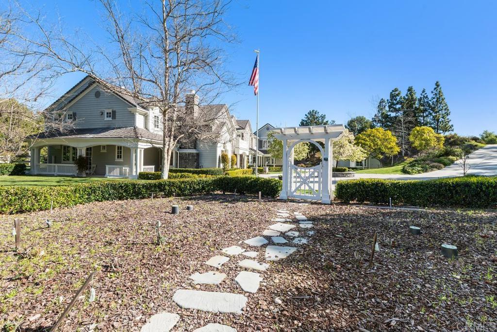 3056 Wildflower Drive Encinitas, CA 92024 - Photo 49 of 56 a front view of a house with a yard and garage