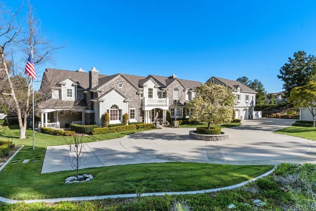 3056 Wildflower Drive Encinitas, CA 92024 - Photo 10 of 56 a view of a white house in front of a big yard with plants and large trees