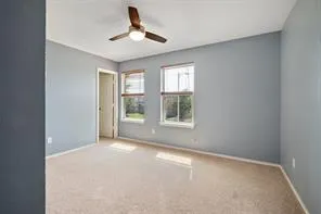 a view of a room with windows and ceiling fan