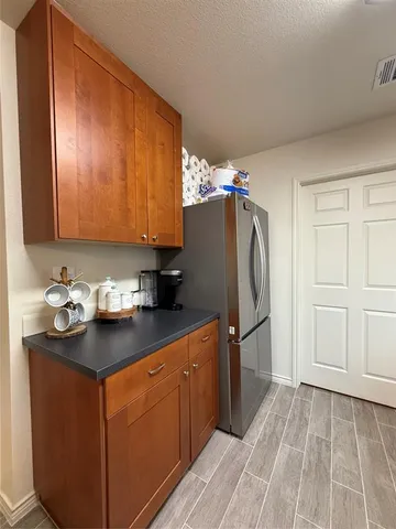 a kitchen with stainless steel appliances granite countertop a refrigerator and a sink