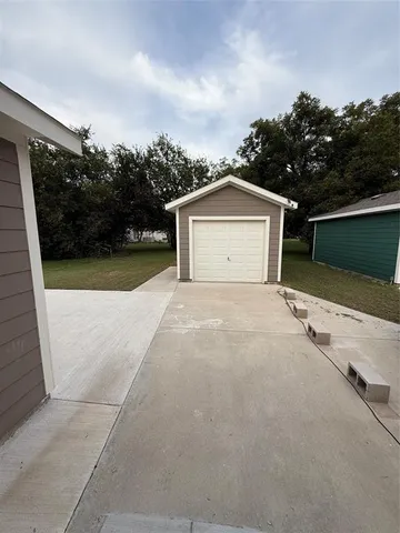 a view of backyard of house with green space