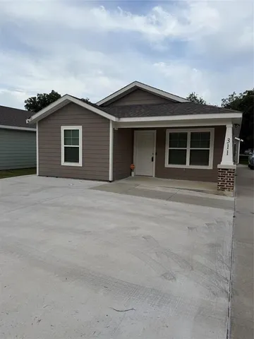 a front view of a house with yard