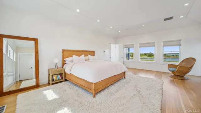 a bed room with a bed and a chair