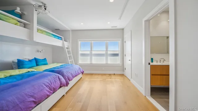 a spacious bedroom with a bed and a window