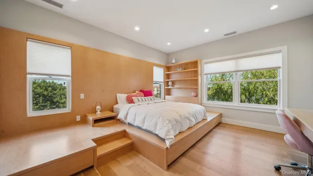 a bedroom with a large bed and a large window