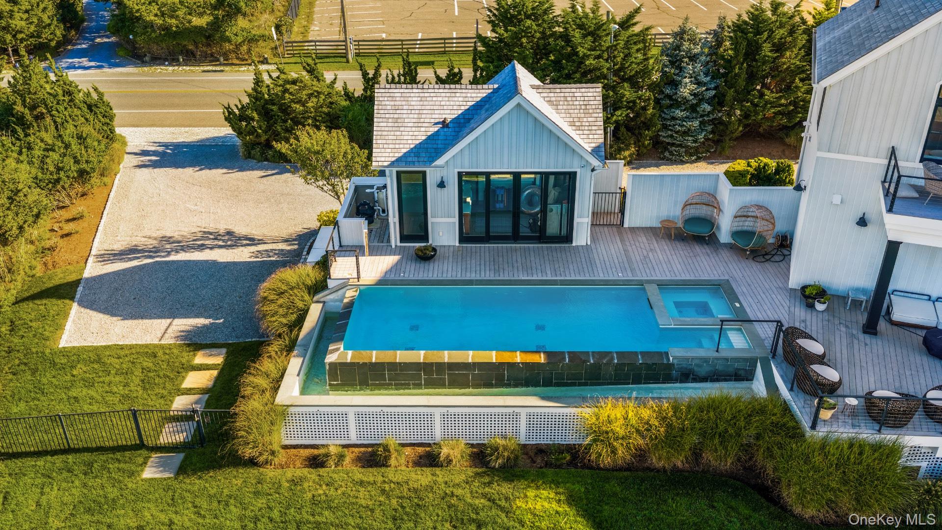 102-92 Dune Road Westhampton Beach, NY 11978 - Photo 33 of 40 Back of house with a patio and a pool with connected hot tub