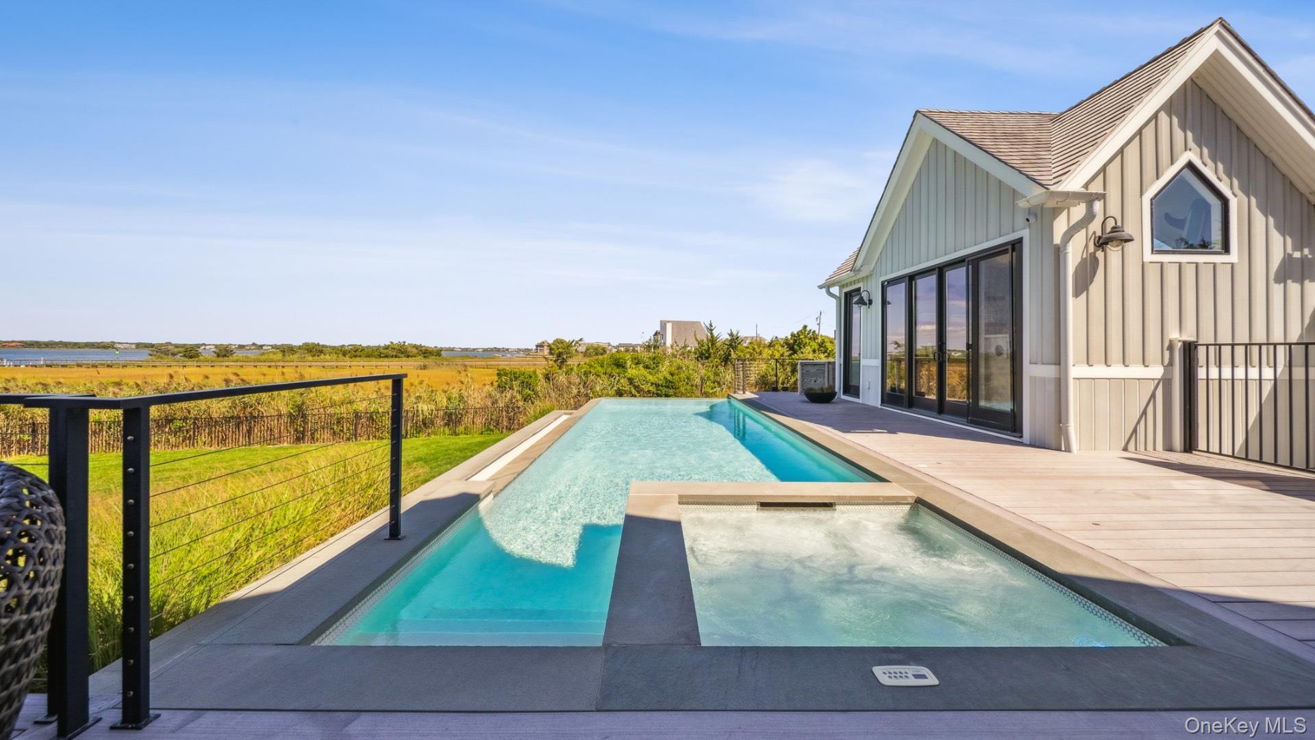 102-92 Dune Road Westhampton Beach, NY 11978 - Photo 35 of 40 View of pool featuring a pool with connected hot tub and a view of countryside