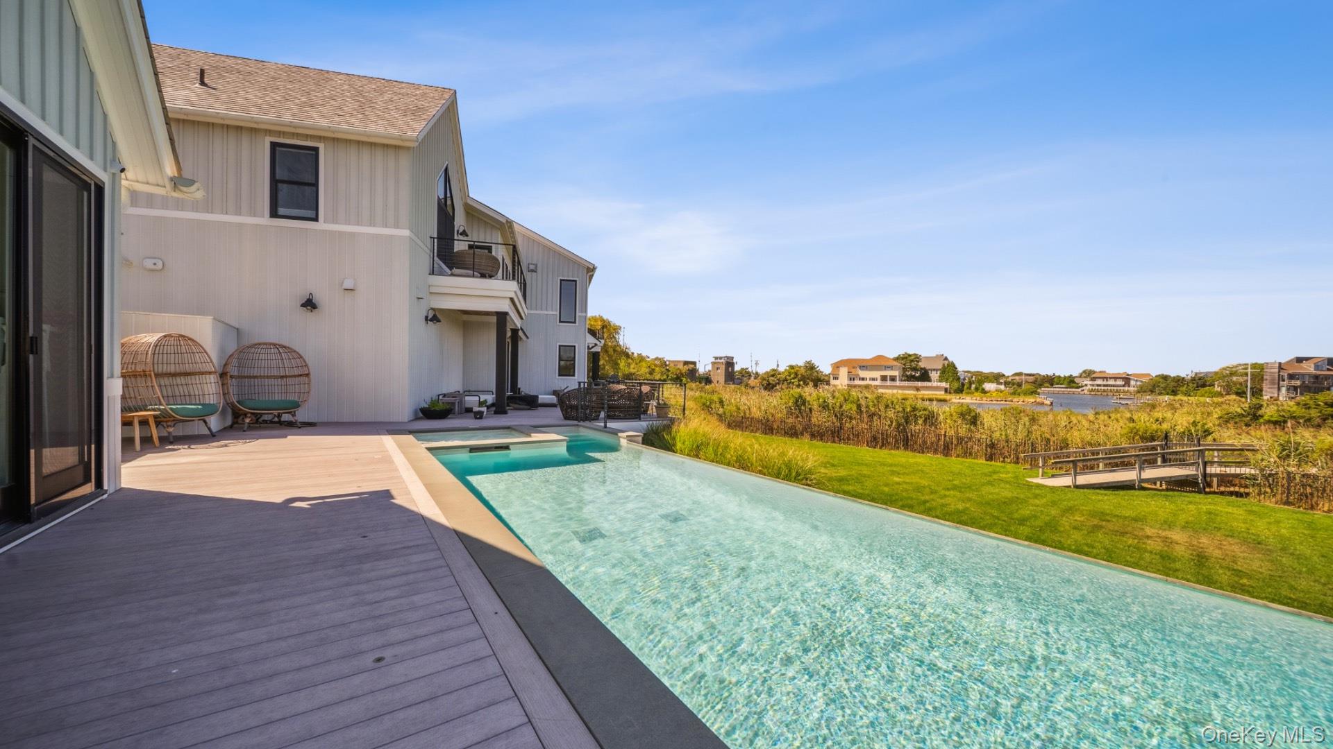 102-92 Dune Road Westhampton Beach, NY 11978 - Photo 37 of 40 View of pool with a yard, an infinity pool, a balcony, and a patio