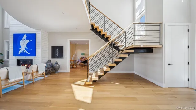 a view of entryway and hall with wooden floor