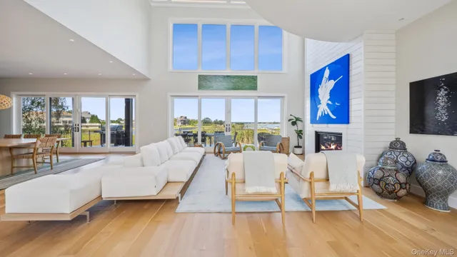 a living room with fireplace furniture and a large window