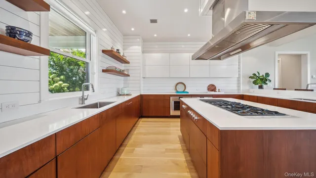 a kitchen with stainless steel appliances granite countertop a sink and a stove