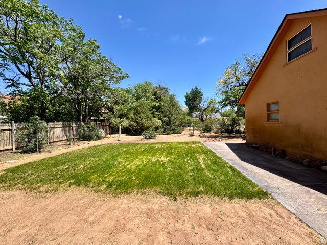 178 Walnut Lane Moab, UT 84532 - Photo 8 of 25 Manicured lawn area bordered by a concrete walkway
