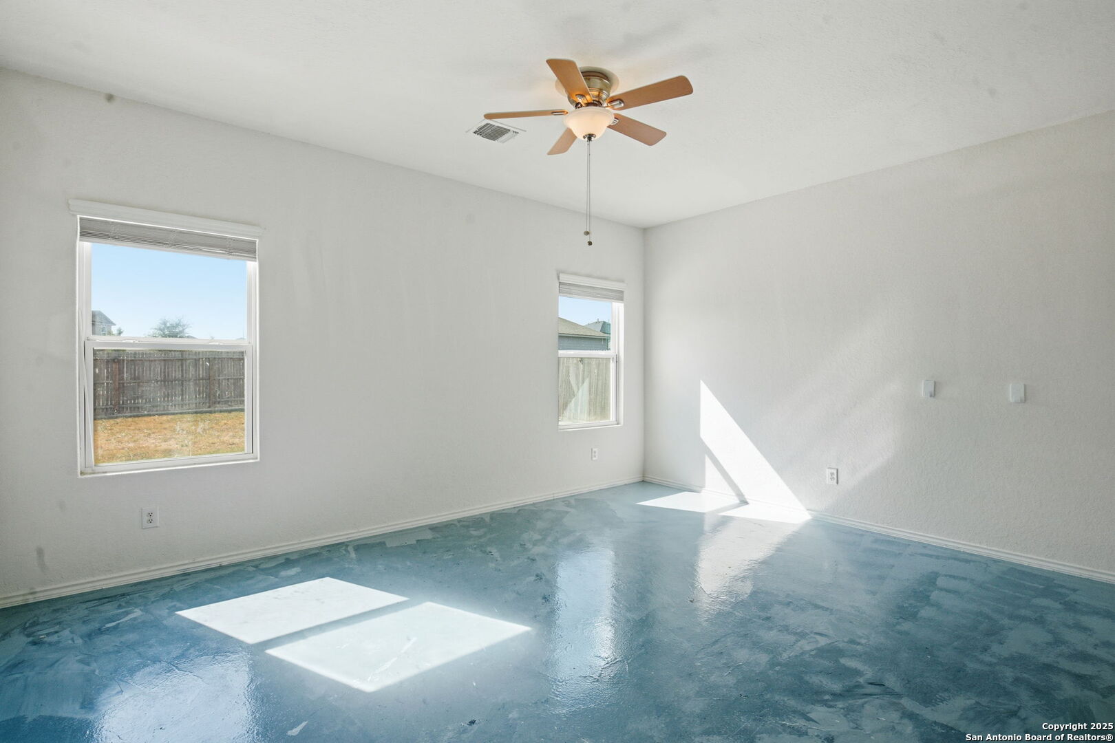 7338 Storm Moon Converse, TX 78109 - Photo 12 of 31 an empty room with a window and a fan