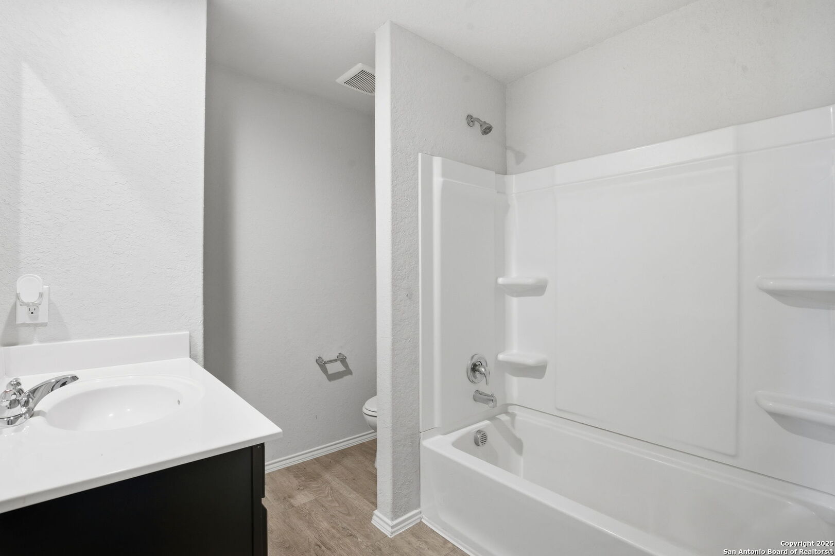 7338 Storm Moon Converse, TX 78109 - Photo 28 of 31 a bathroom with a bathtub sink vanity and toilet