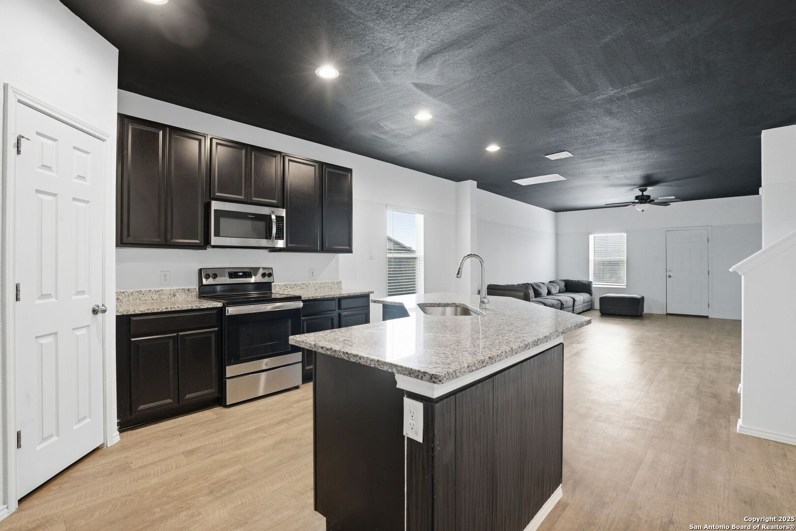 7338 Storm Moon Converse, TX 78109 - Photo 6 of 31 a kitchen with sink a refrigerator and chairs