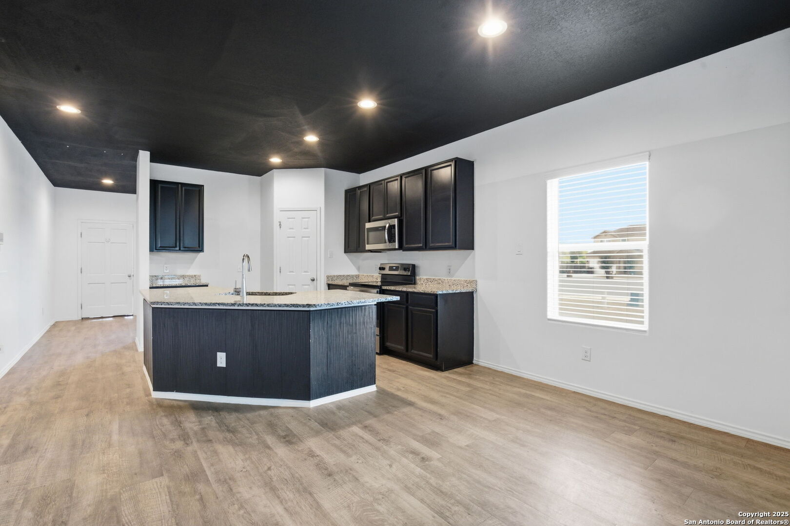7338 Storm Moon Converse, TX 78109 - Photo 8 of 31 a kitchen with stainless steel appliances granite countertop a stove a sink and a refrigerator