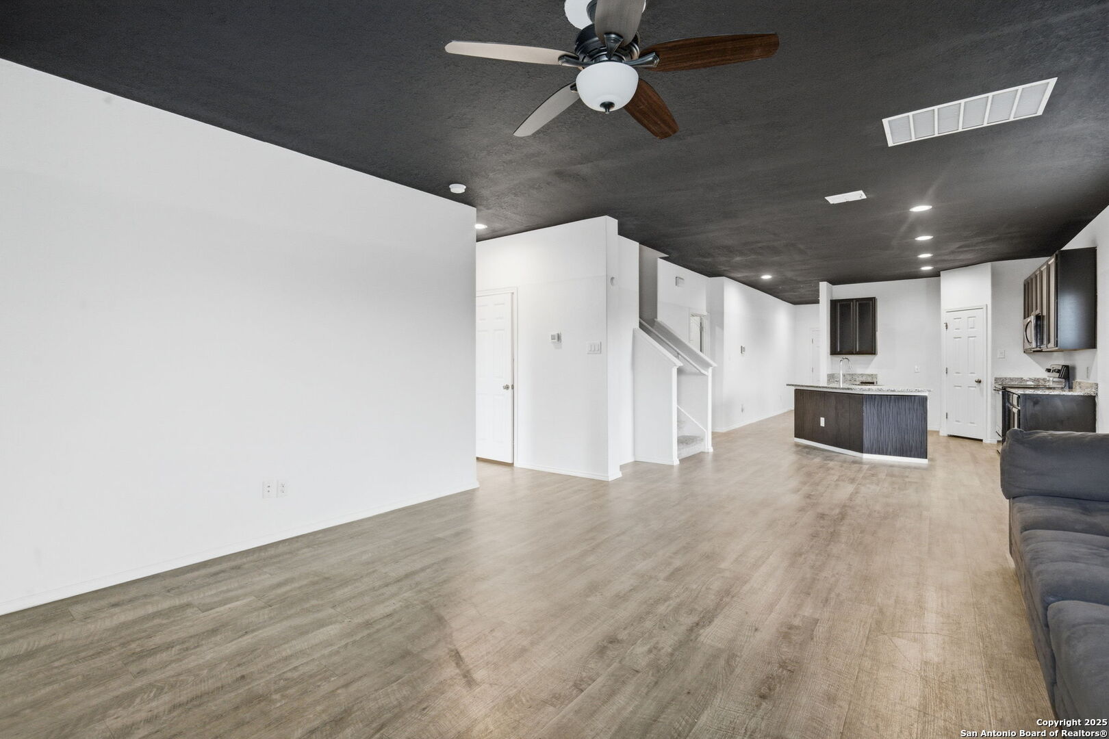 7338 Storm Moon Converse, TX 78109 - Photo 10 of 31 a view of a livingroom with wooden floor and a ceiling fan
